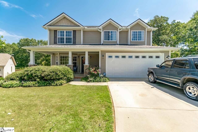 view of front facade featuring a garage, a porch, and a front lawn