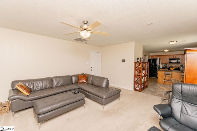 living room featuring light tile patterned flooring and ceiling fan