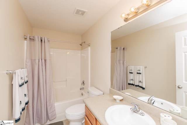 full bathroom featuring a textured ceiling, vanity, shower / tub combo, and toilet