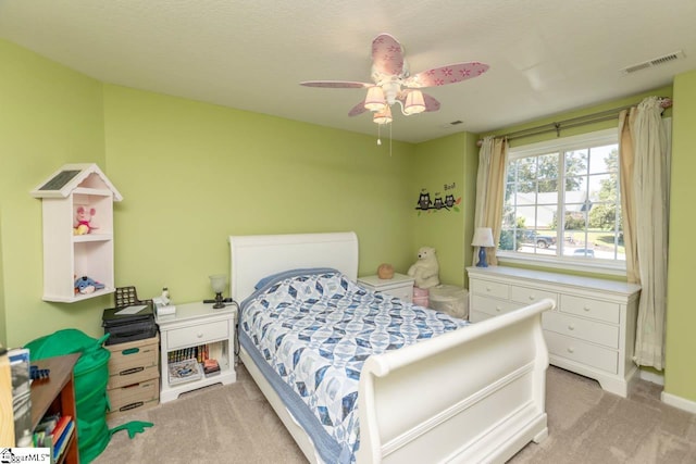 bedroom with ceiling fan and light carpet