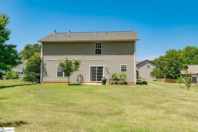 rear view of property featuring a yard