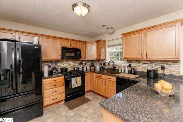 kitchen featuring decorative backsplash, sink, black appliances, a textured ceiling, and light tile patterned floors