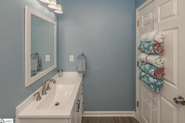 bathroom with hardwood / wood-style flooring and vanity