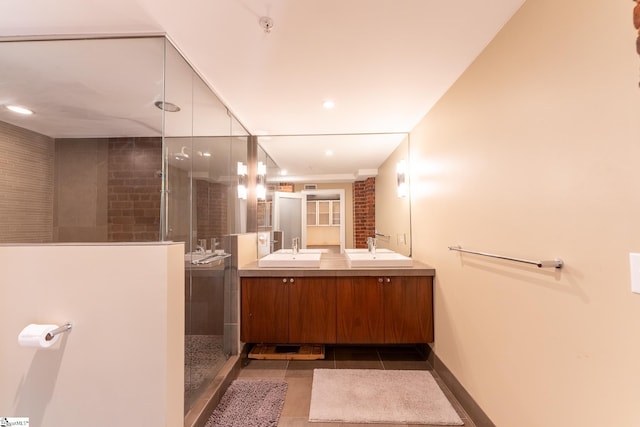 bathroom with tile patterned floors, tiled shower, and vanity