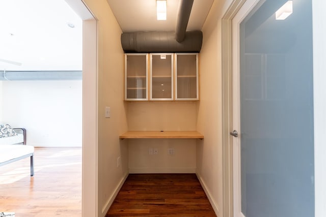 corridor featuring dark hardwood / wood-style flooring