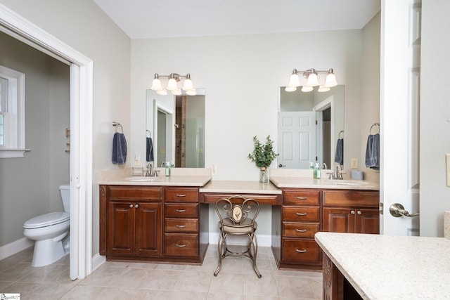 full bathroom with two vanities, a sink, toilet, and tile patterned floors