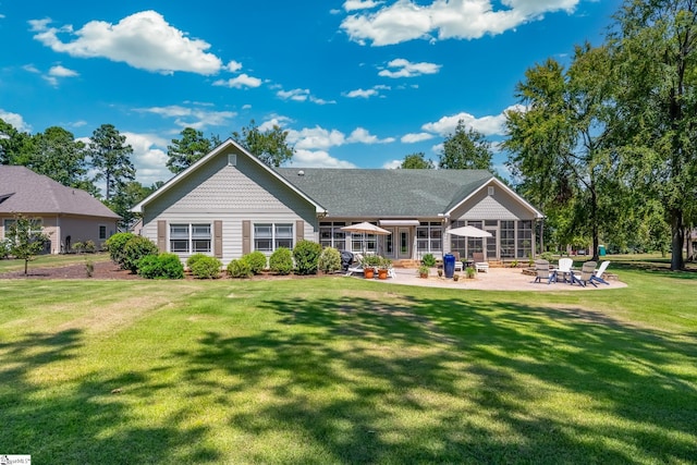 back of property featuring a lawn and a patio