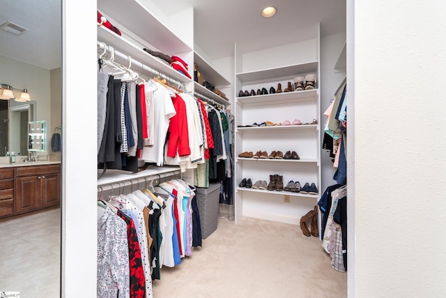 walk in closet featuring light carpet and visible vents