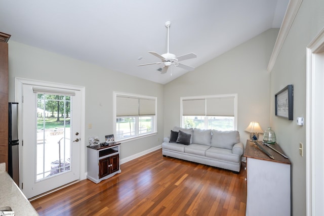 living area featuring lofted ceiling, baseboards, a ceiling fan, and dark wood-style flooring