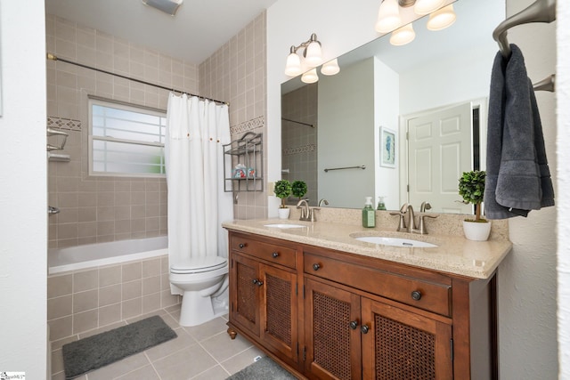 full bathroom with tiled shower / bath, double vanity, tile patterned flooring, and a sink