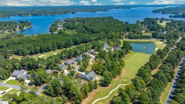 bird's eye view with a water view and a wooded view