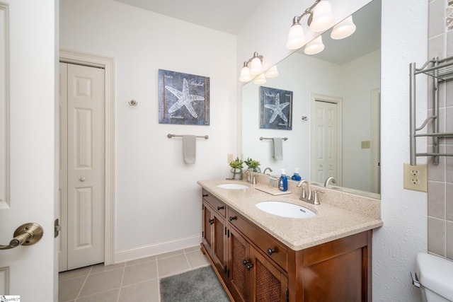 full bath featuring tile patterned flooring, a closet, a sink, and double vanity