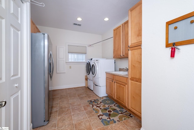 clothes washing area featuring cabinet space, visible vents, washing machine and dryer, a sink, and recessed lighting