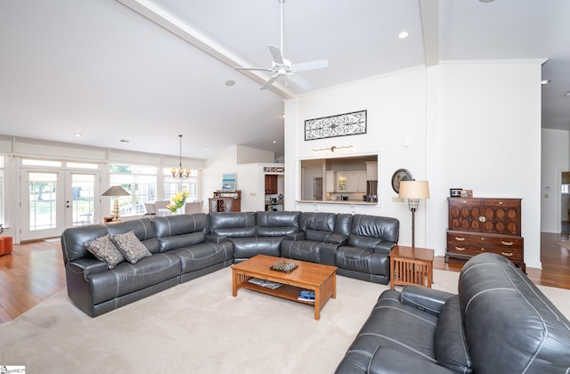 living room featuring ceiling fan with notable chandelier, high vaulted ceiling, recessed lighting, and light wood-style floors