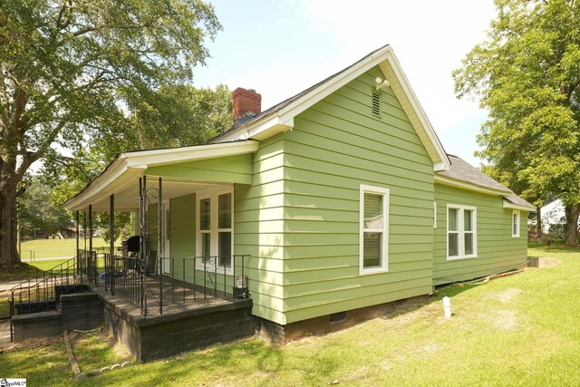 rear view of house with a lawn