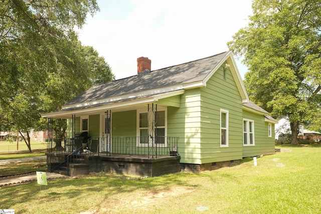 exterior space with a lawn and a porch