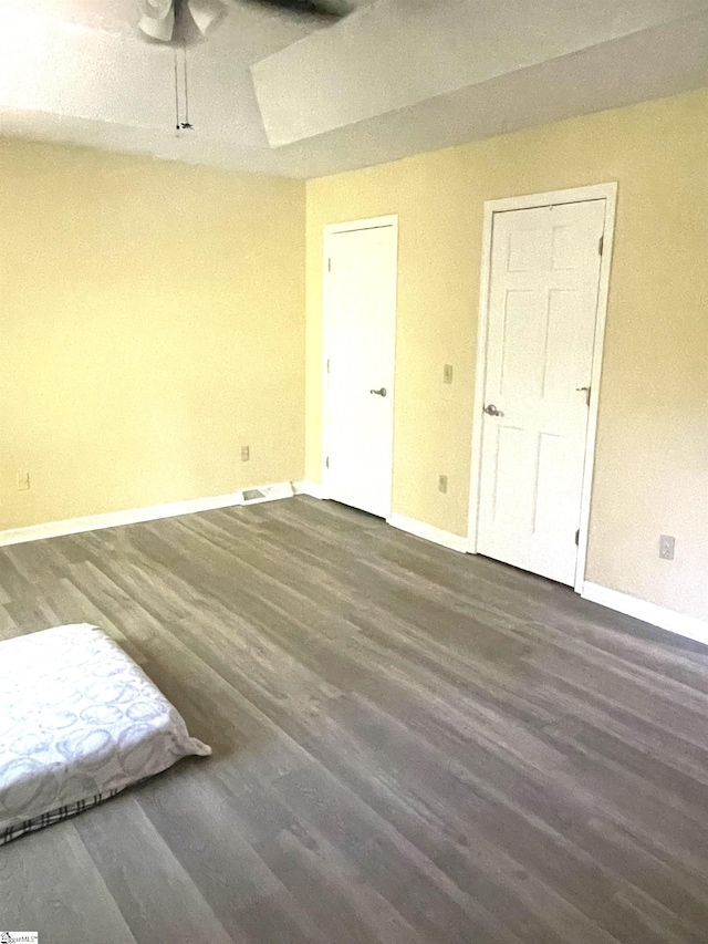 spare room with ceiling fan and dark hardwood / wood-style flooring