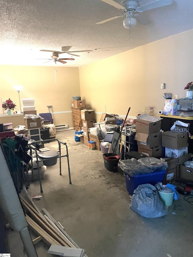 miscellaneous room with a textured ceiling, ceiling fan, a baseboard heating unit, and concrete floors