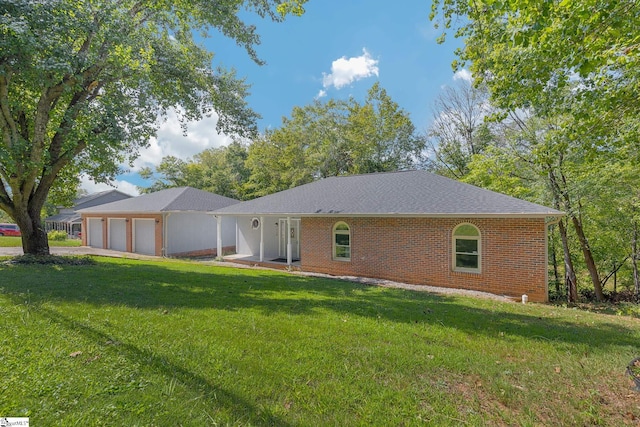 ranch-style home with a garage, a front lawn, and brick siding