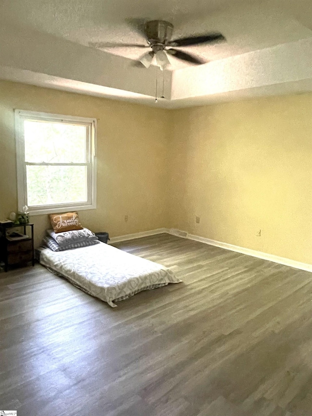 unfurnished bedroom with hardwood / wood-style floors and ceiling fan