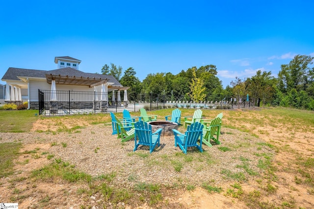 view of yard featuring a pergola and a fire pit