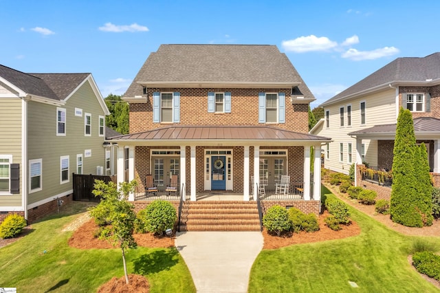 view of front of property with a front lawn and covered porch