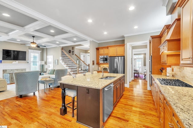 kitchen featuring crown molding, light hardwood / wood-style flooring, appliances with stainless steel finishes, coffered ceiling, and ceiling fan