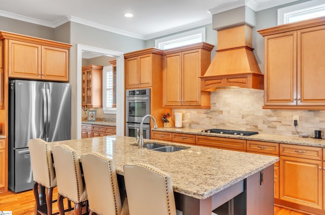 kitchen featuring light wood-type flooring, appliances with stainless steel finishes, and backsplash