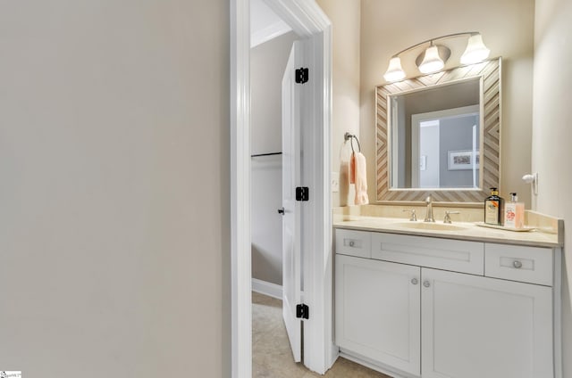 bathroom with tile patterned flooring and vanity