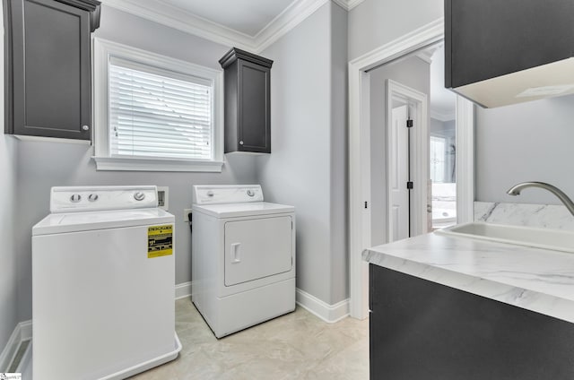 laundry area with cabinets, light tile patterned floors, independent washer and dryer, ornamental molding, and sink