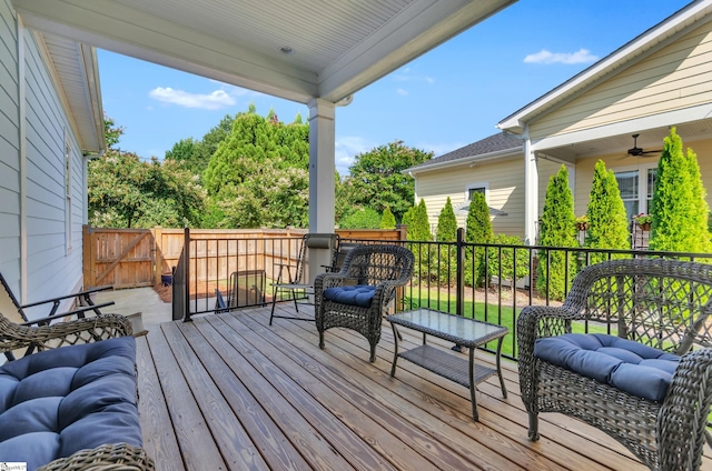 wooden terrace featuring ceiling fan and an outdoor hangout area