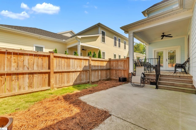 view of yard with french doors, a patio area, and ceiling fan