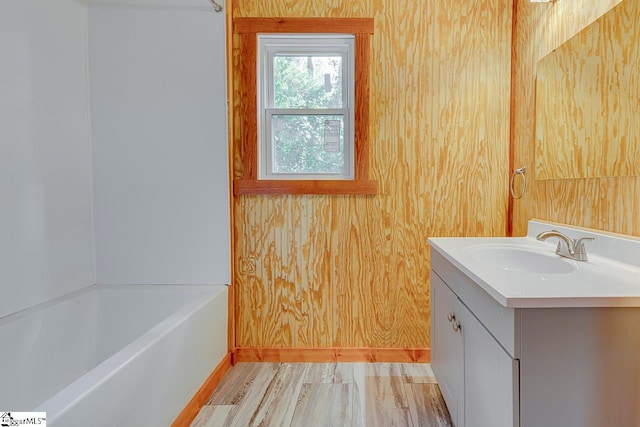 bathroom with a tub to relax in and vanity