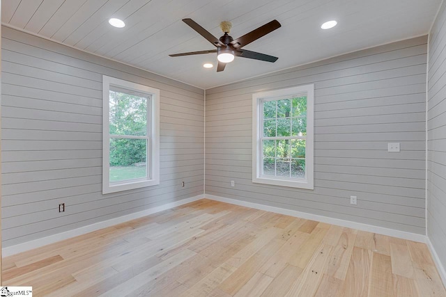 unfurnished room with plenty of natural light and light hardwood / wood-style floors