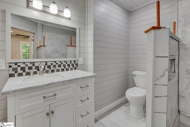 bathroom featuring tile patterned floors, tile walls, toilet, and vanity