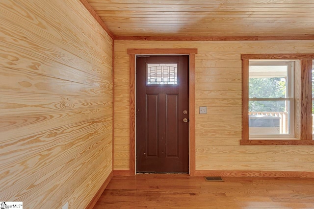 doorway to outside featuring wood walls, wood ceiling, and hardwood / wood-style flooring