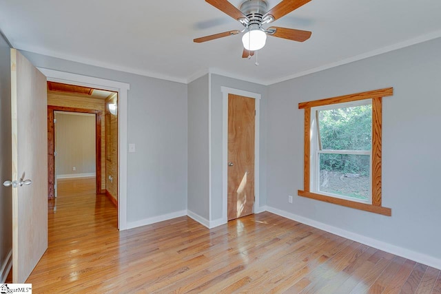 unfurnished bedroom featuring light wood-type flooring, crown molding, and ceiling fan