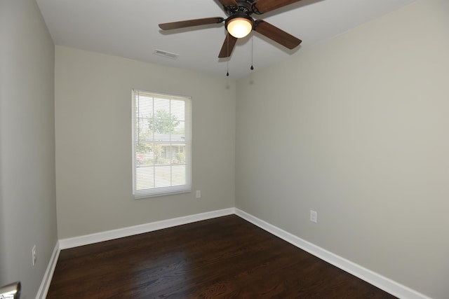 empty room with ceiling fan and dark hardwood / wood-style flooring