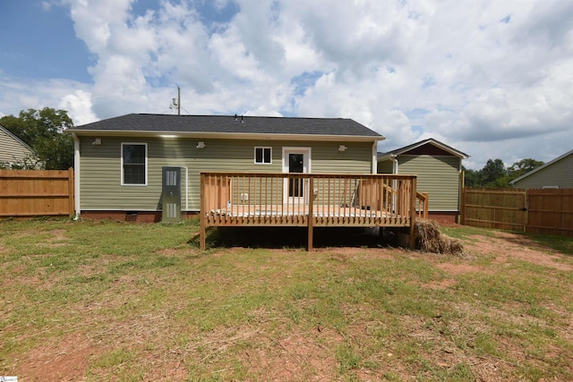 back of house featuring a yard and a deck