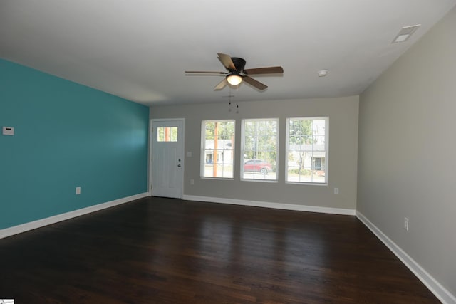 unfurnished room featuring dark wood-type flooring and ceiling fan