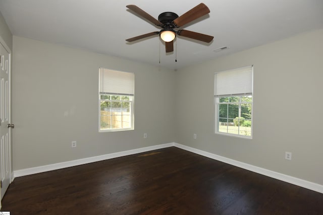 empty room featuring ceiling fan and dark hardwood / wood-style floors