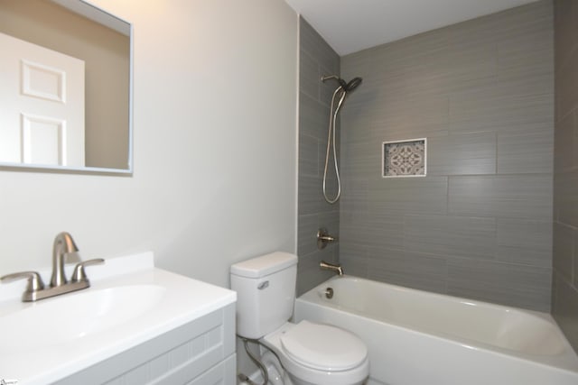 full bathroom with toilet, tiled shower / bath combo, and vanity