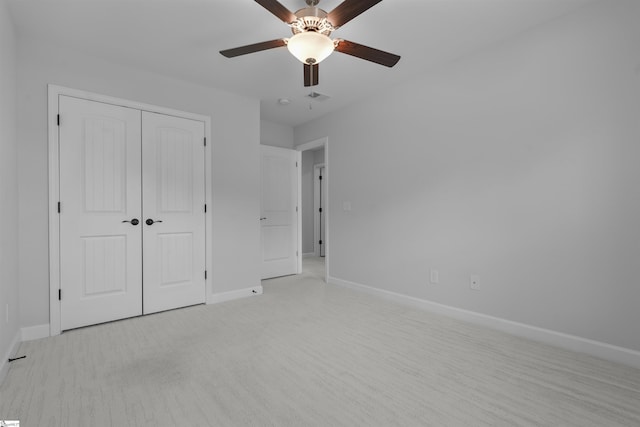 unfurnished bedroom featuring a closet, visible vents, a ceiling fan, and baseboards