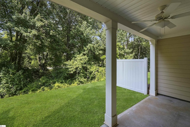 view of yard featuring ceiling fan and fence