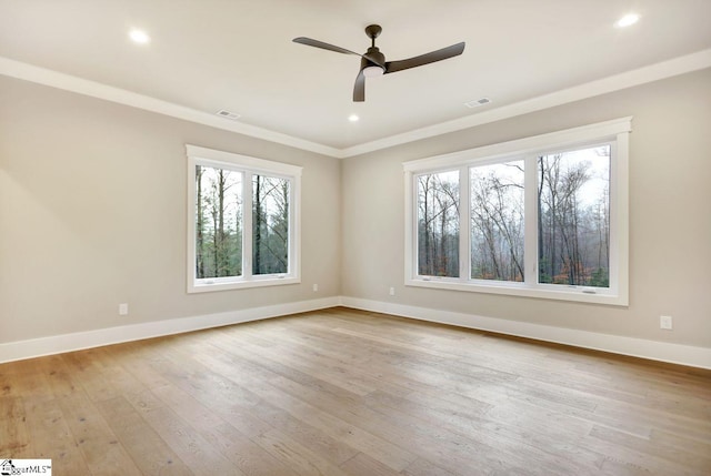 unfurnished room featuring plenty of natural light, ceiling fan, and light wood-type flooring