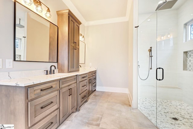 bathroom with ornamental molding, vanity, a shower with shower door, and tile patterned floors