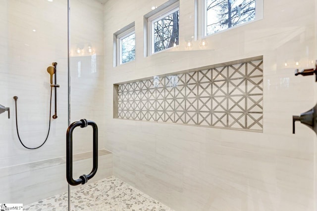 bathroom with a tile shower