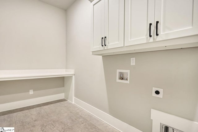 clothes washing area featuring washer hookup, hookup for an electric dryer, and cabinets