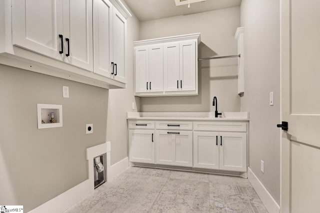 clothes washing area with hookup for a washing machine, cabinets, light tile patterned floors, sink, and electric dryer hookup