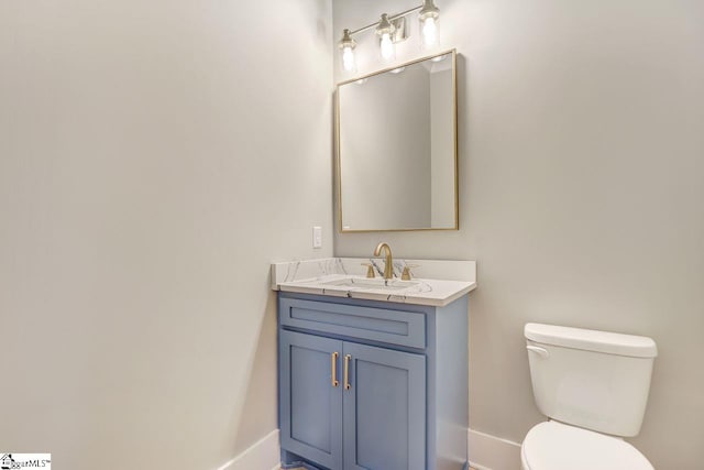 bathroom featuring toilet and vanity